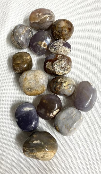 Collection of Purple Chalcedony Crystals on a light fabric background