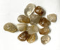 Collection of Rutilated Quartz gemstones on a white fabric background showing one side