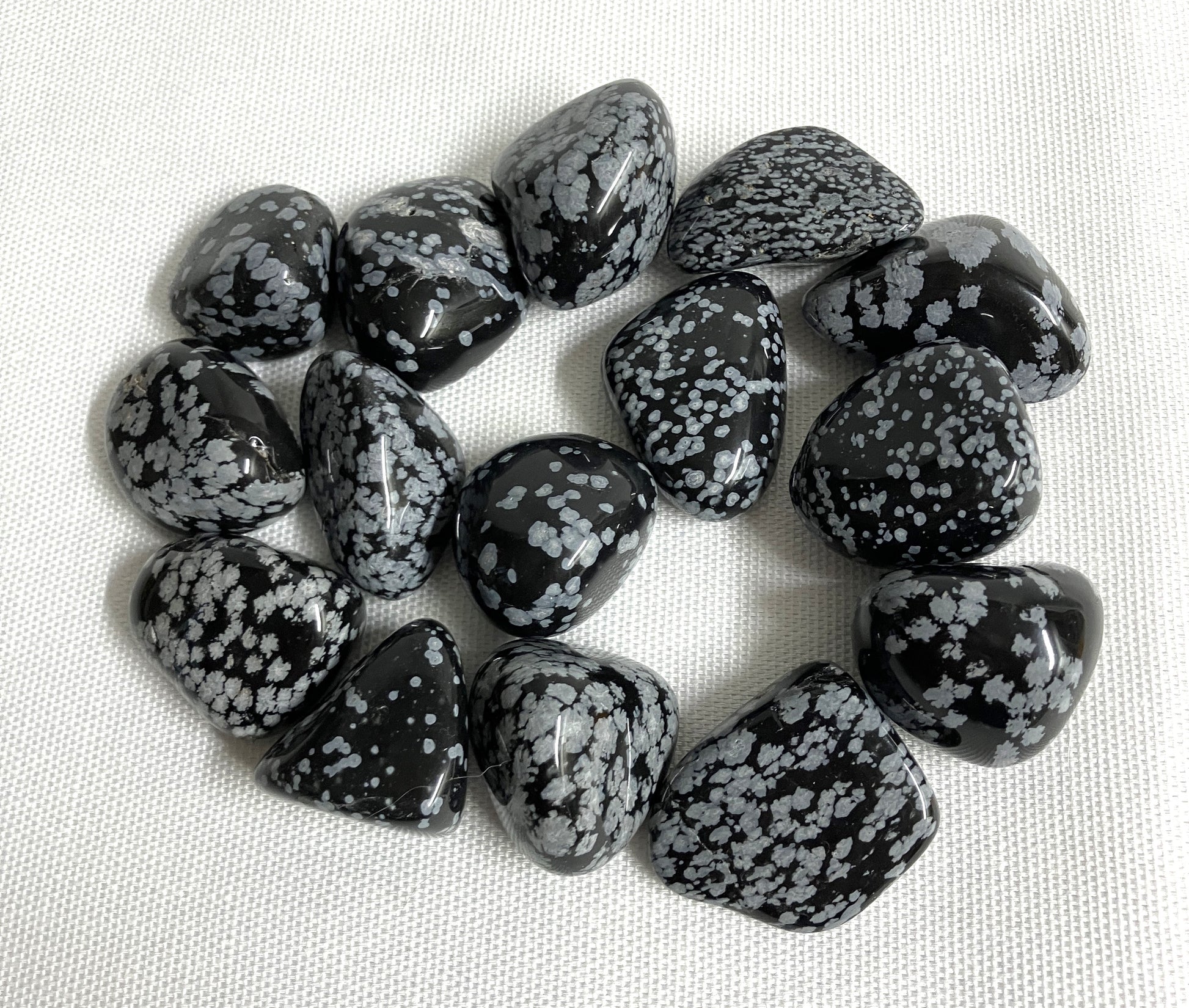 Snowflake Obsidian Crystals on a light fabric background