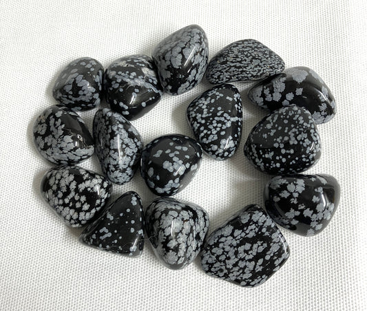 Snowflake Obsidian Crystals on a light fabric background