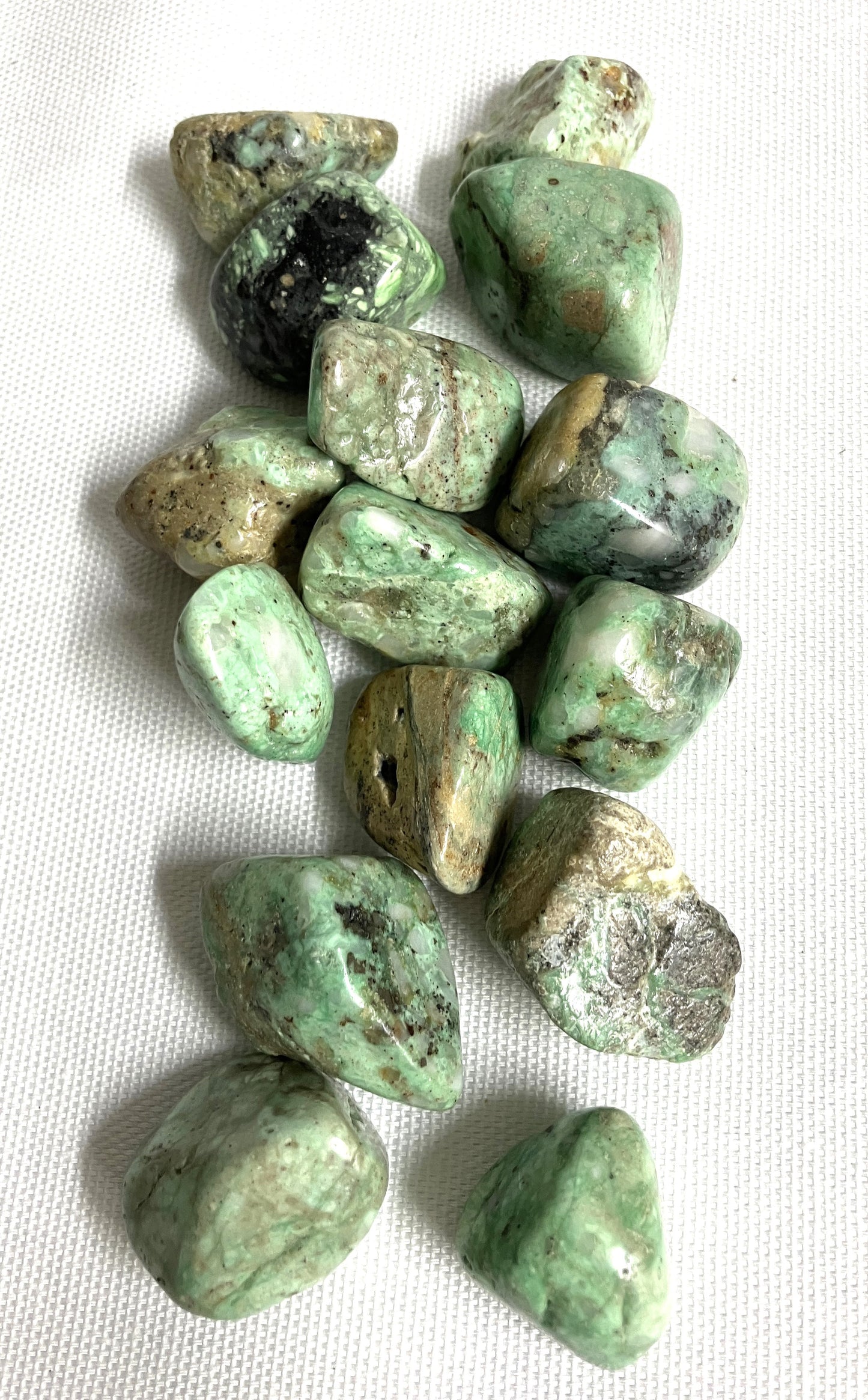 Variscite Crystals showing the patterns on a white fabric background