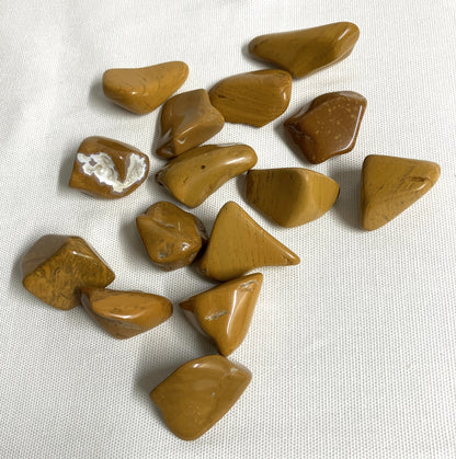 Back view of Yellow Jasper Crystals on a white fabric background