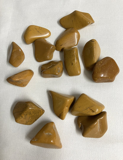 Front view of Yellow Jasper Crystals on a white fabric background