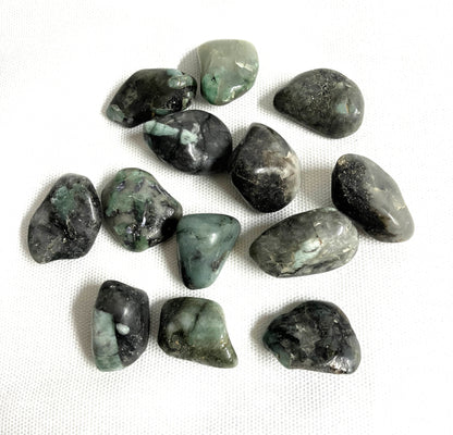 Group of Emerald Crystals  showing a different side on a white fabric background