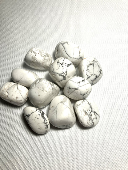 Howlite Crystals showing the front veining on a light gray fabric background