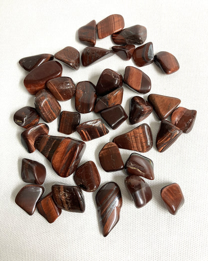Red Tiger Eye tumbled crystals showing the variety of patterns and styles
