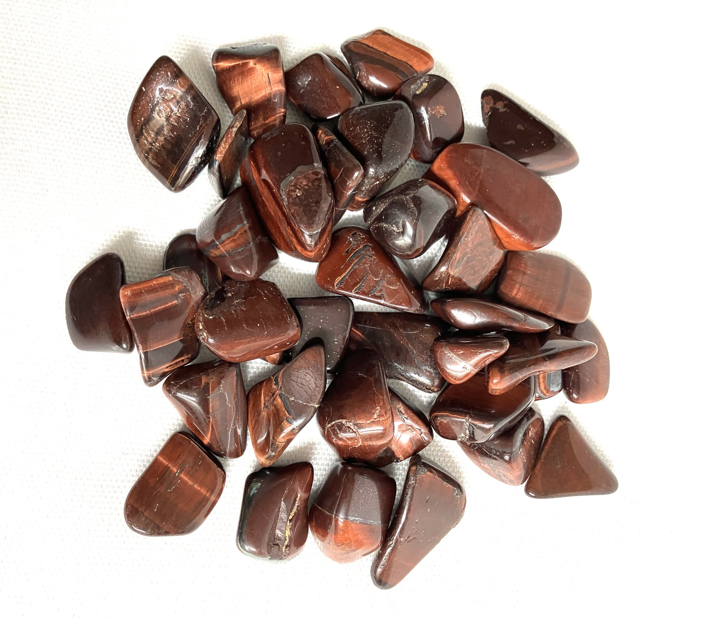 View of Red Tiger Eye tumbled Crystals showing variations in patterns
