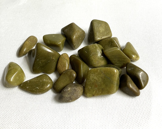 Closeup of Green Opal Crystals on a white fabric background