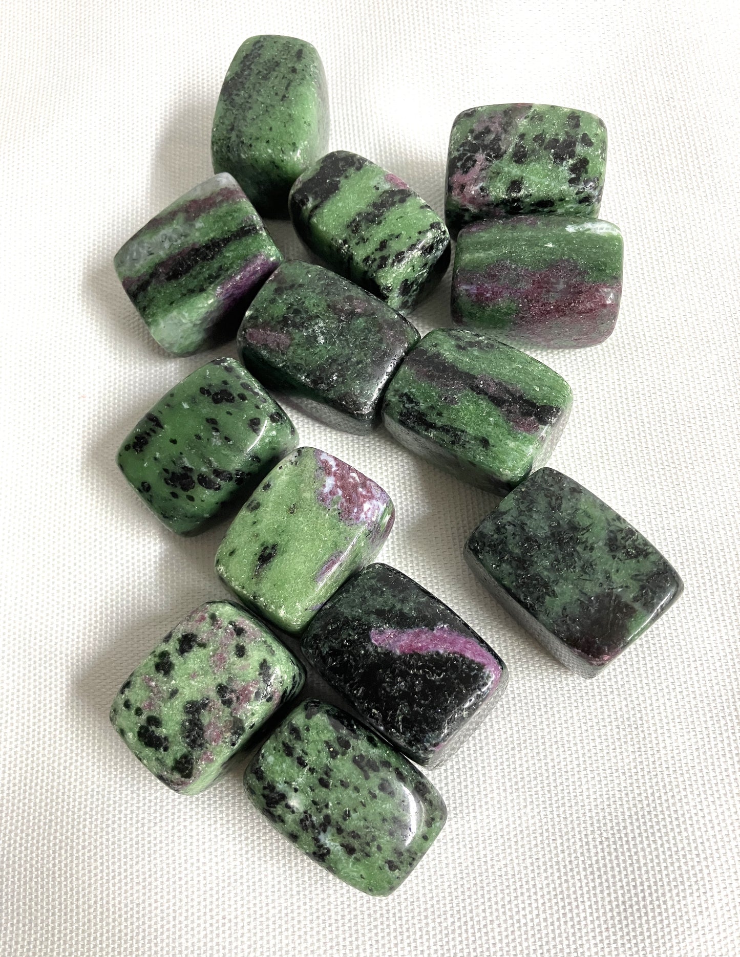 Ruby in Zoisite Crystals showing the Green and purple coloring on a white background