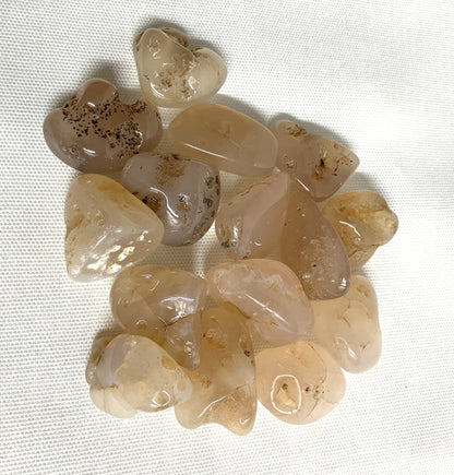 Collection of Pink Chalcedony Crystals on a white fabric background