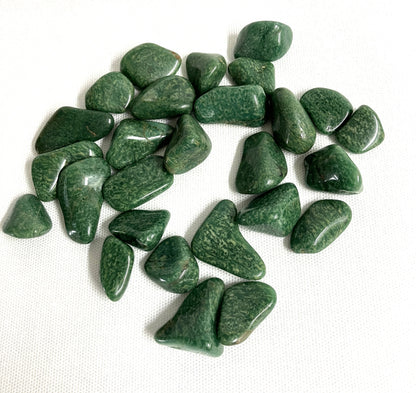 Tumbled Verde Quartz Crystals on a white fabric background