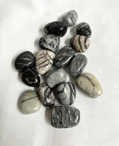 Front view of Spider Web Jasper Crystals on a white fabric background