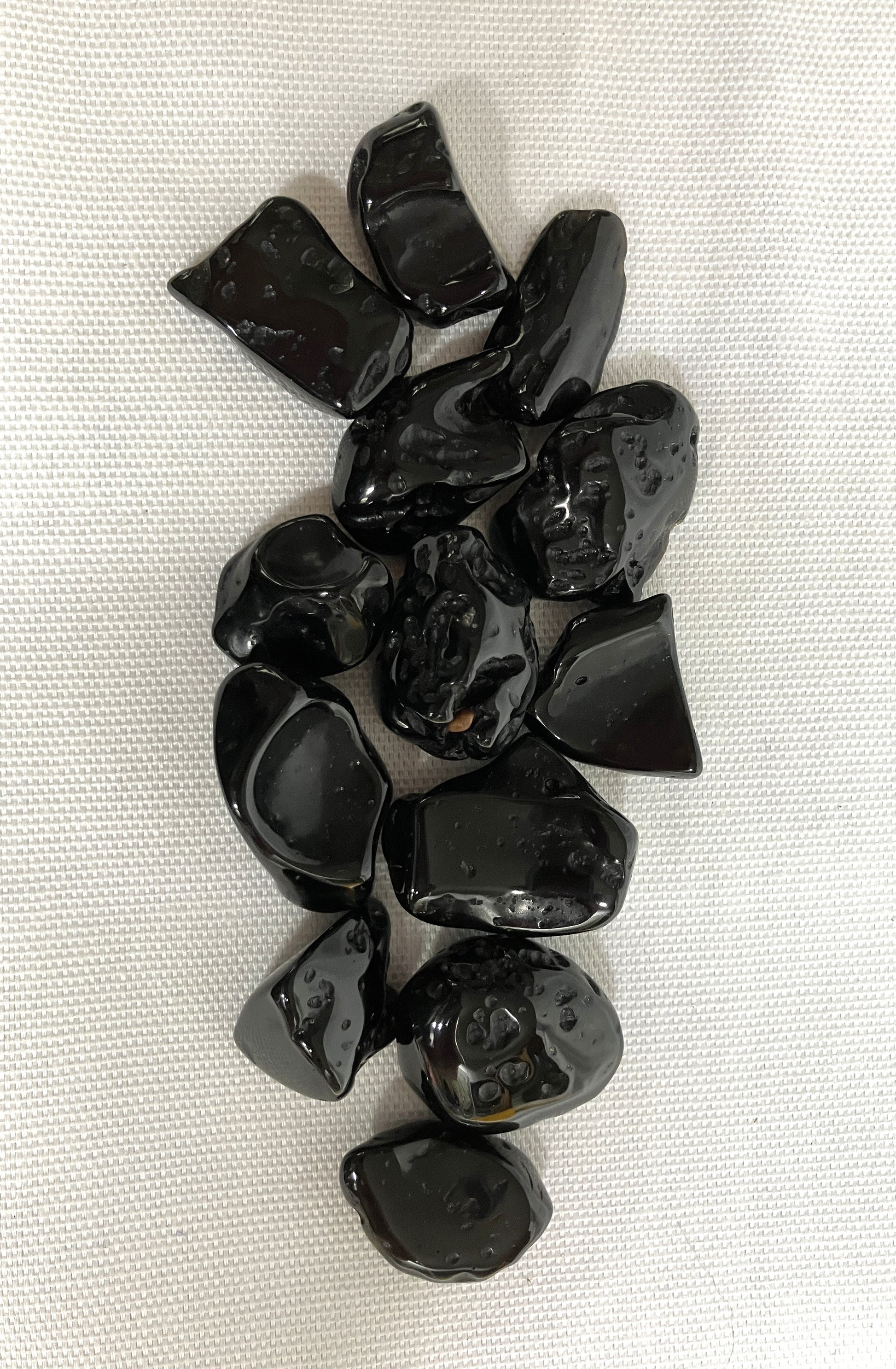 Front view of Tektite Stones on a white fabric background