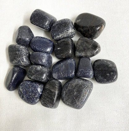 Closeup of Blue Aventurine Tumbled Crystals on a light gray background