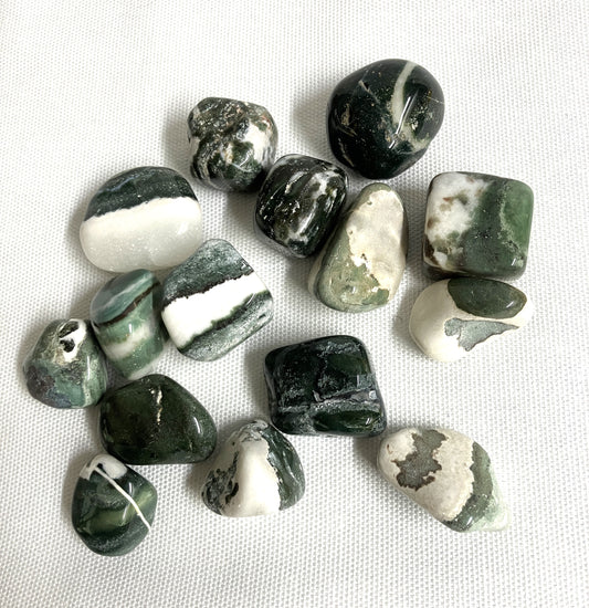 Collection of Green Sardonyx Crystals on a white fabric background