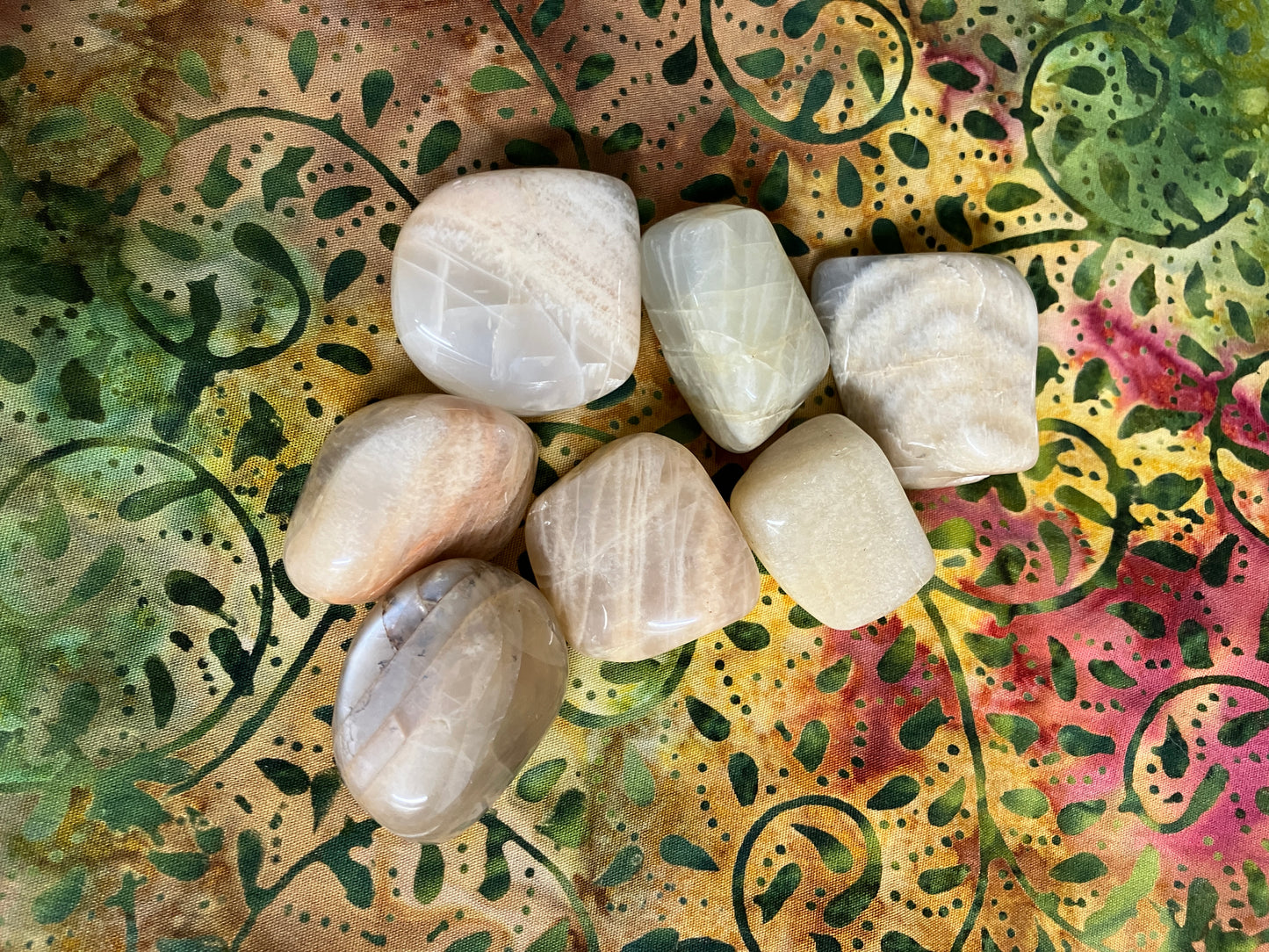 Back view of Moonstone Crystals on a decorative fabric background