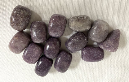 Lepidolite Crystals shown on a white fabric background