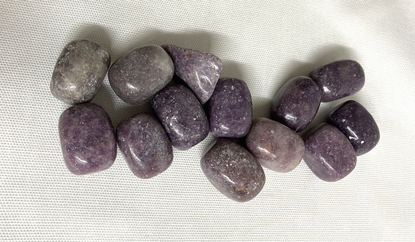 Closeup of Lepidolite Crystals on a white fabric background