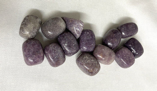 Closeup of Lepidolite Crystals on a white fabric background