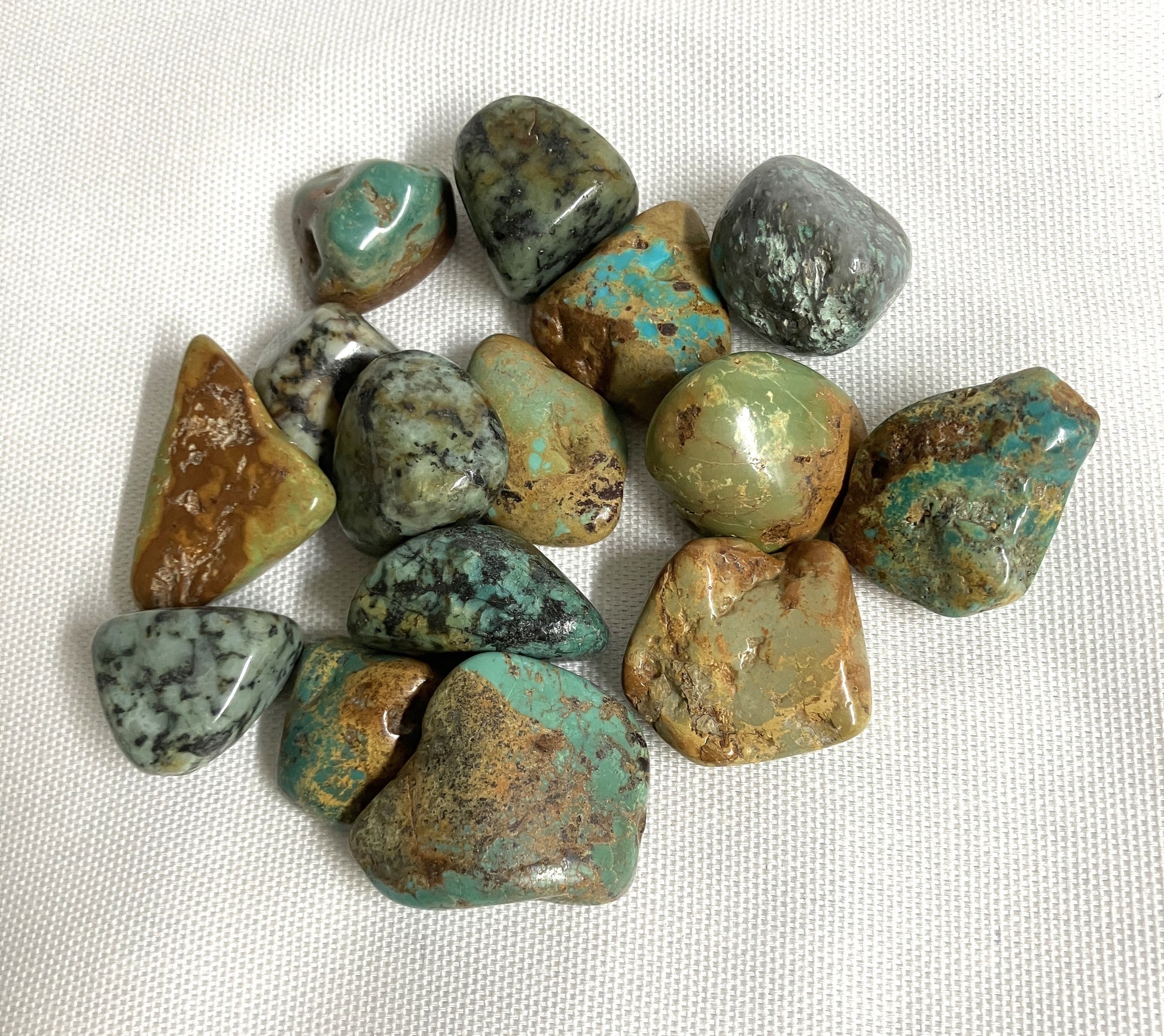 Back view of African Turquoise Crystals on a white fabric background