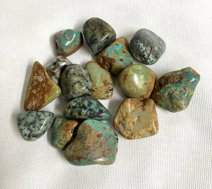 Back view of African Turquoise Crystals on a white fabric background