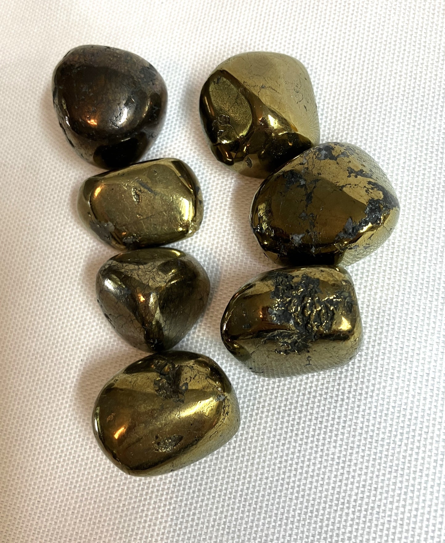 Peacock Ore Crystals AKA Chalcopyrite showing the front side on a white fabric background