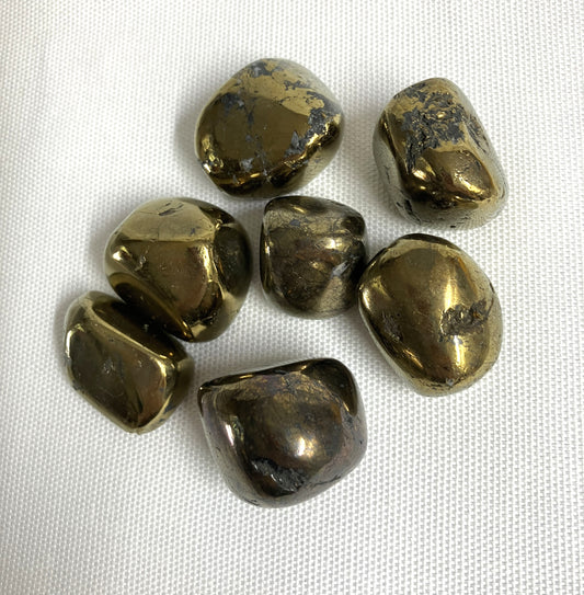 Peacock Ore Crystals AKA Chalcopyrite on a white fabric background