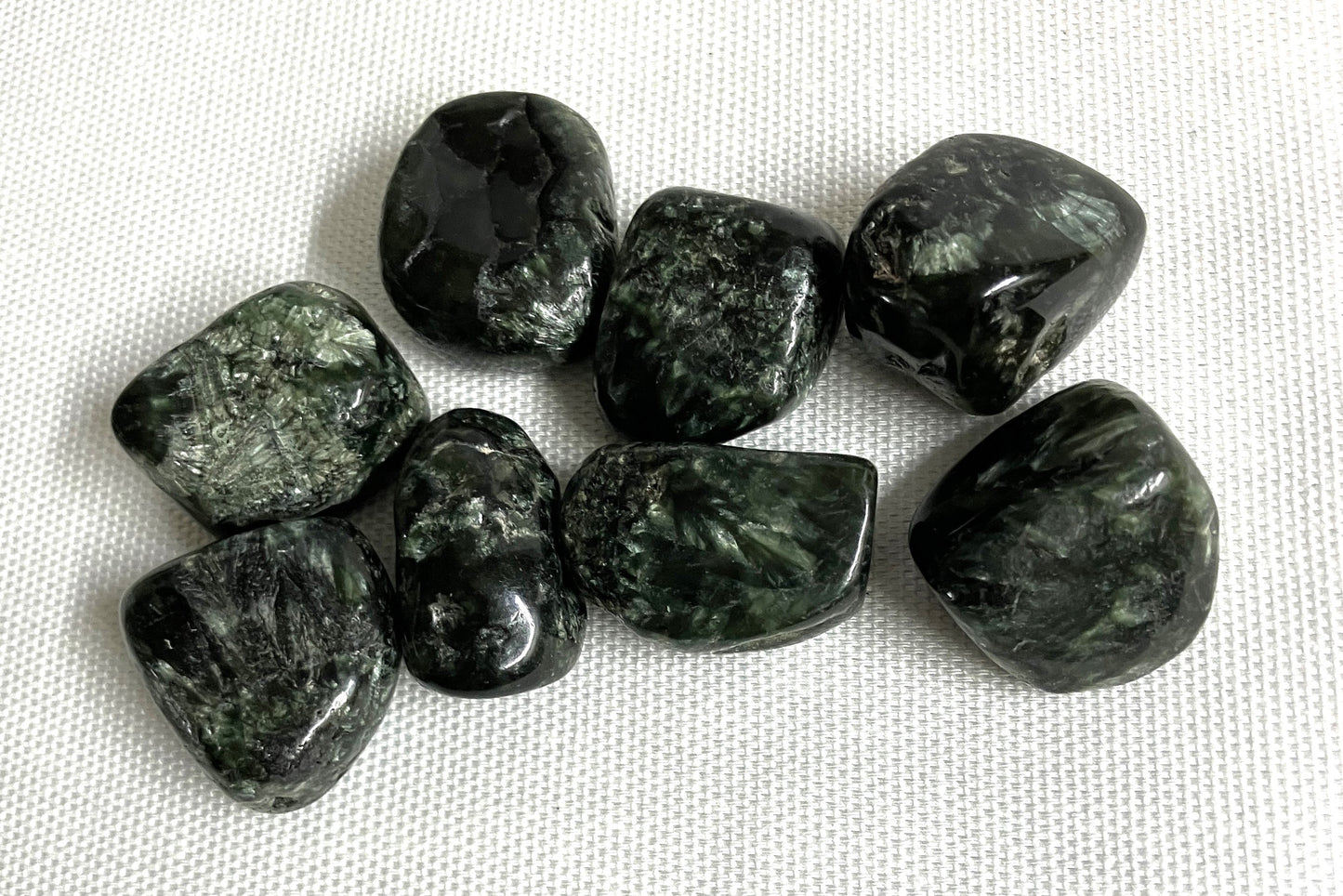 Closeup of Seraphinite Crystals on a white fabric background