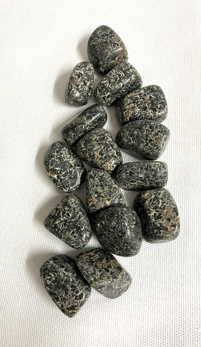 Tumbled Christmas Flower Jasper Crystals  on a white fabric background