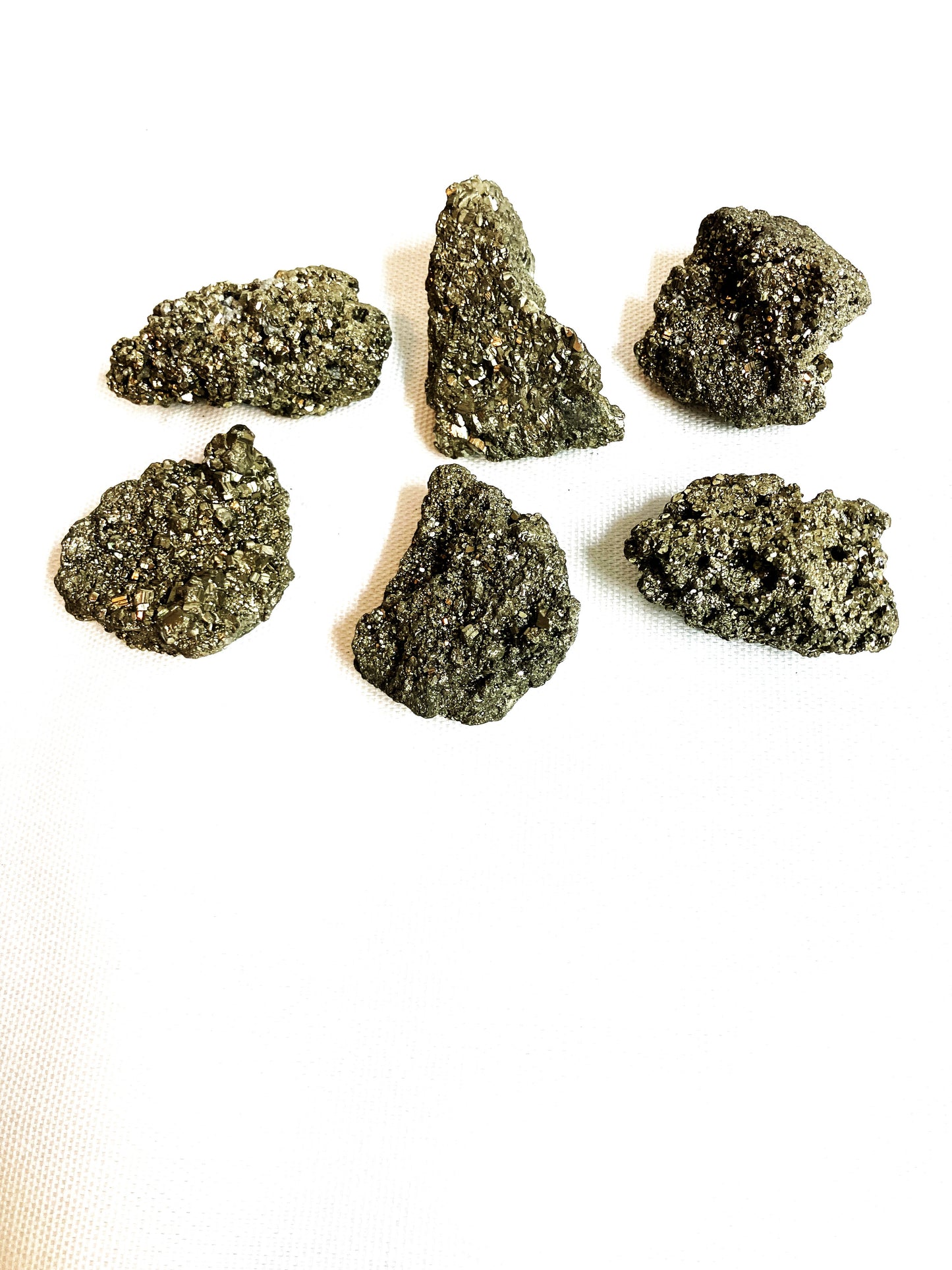 Six Natural Pyrite Crystals AKA Fools Gold on a white background
