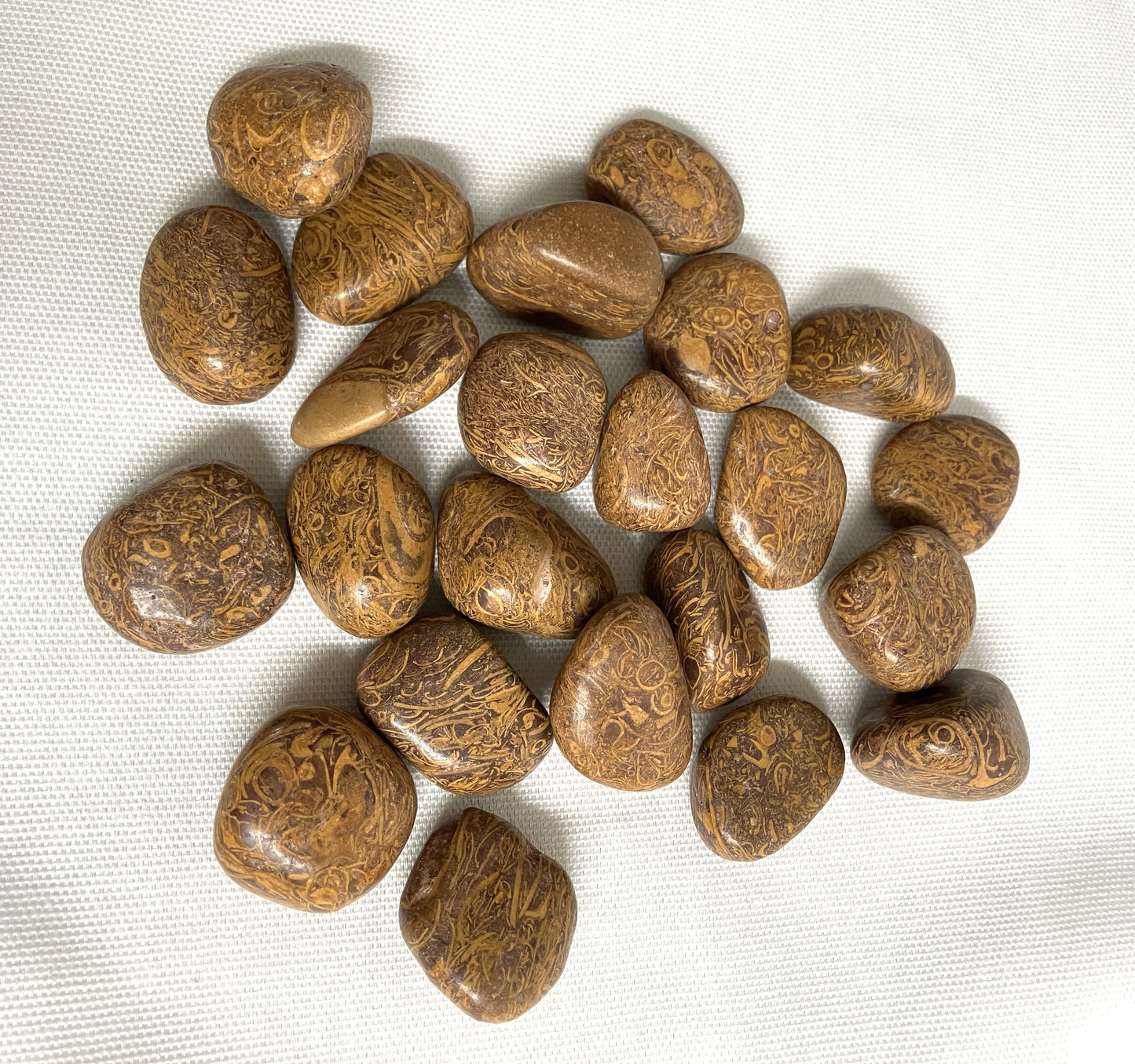 Group of Calligraphy Crystals AKA Mariam Jasper on a white fabric background