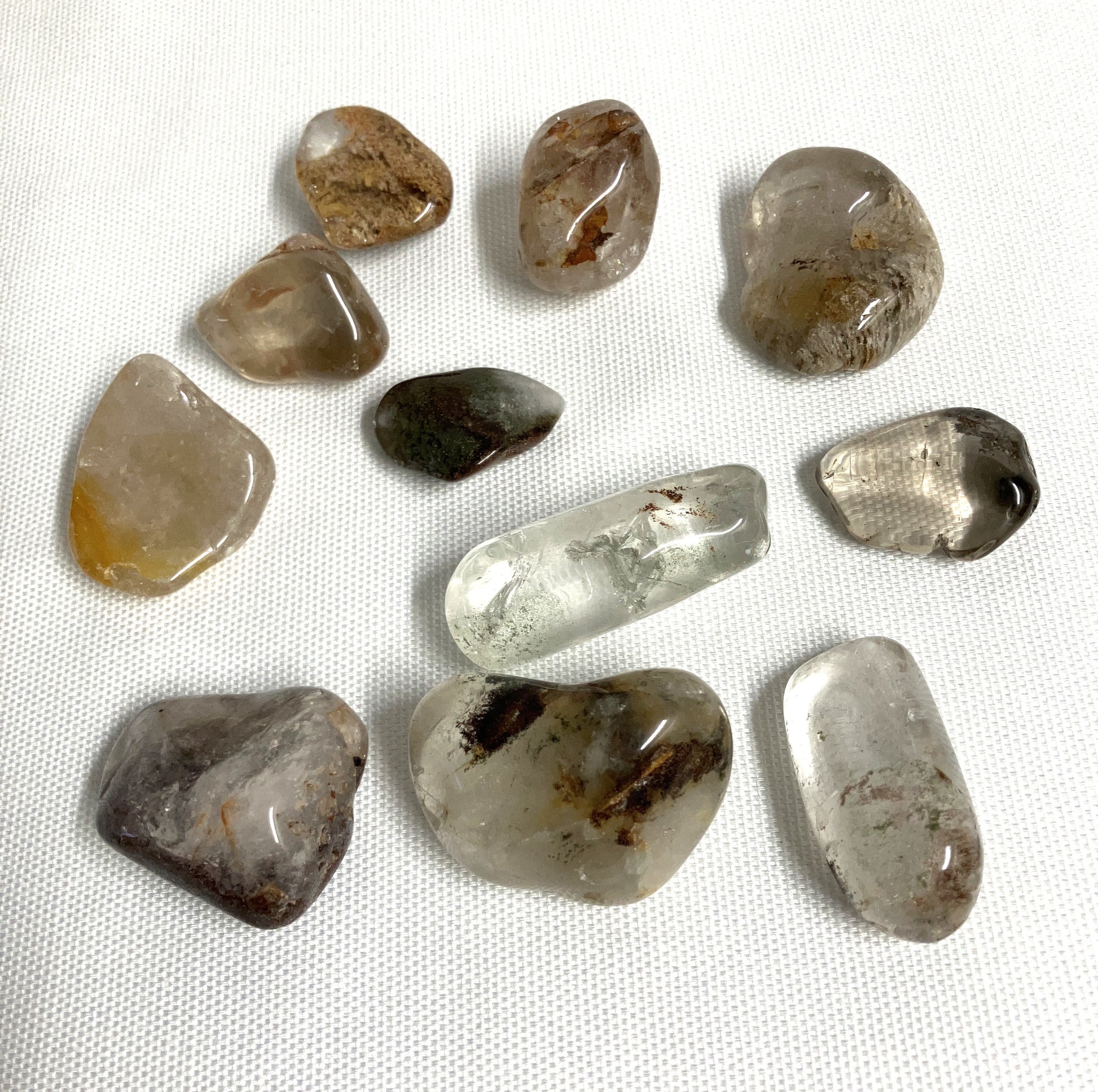 Back view of Lodolite Crystals AKA Garden Quartz on a white fabric background