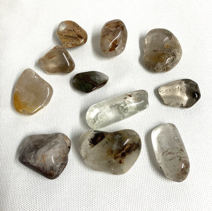 Back view of Lodolite Crystals AKA Garden Quartz on a white fabric background