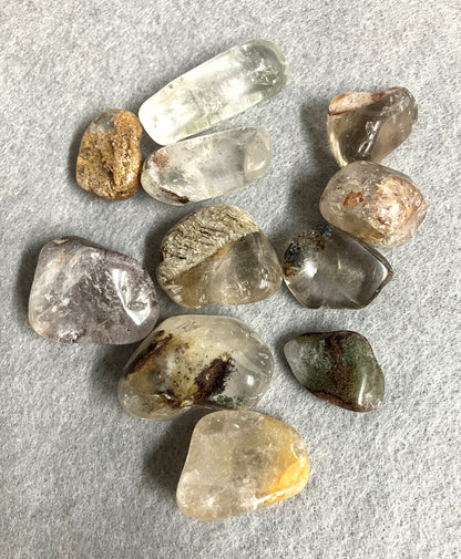 Collection of Lodolite Crystals AKA Garden Quartz on a gray surface