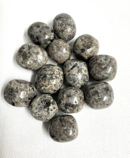 Natural light view of Flame Crystal AKA Yooperlite  on a white fabric background