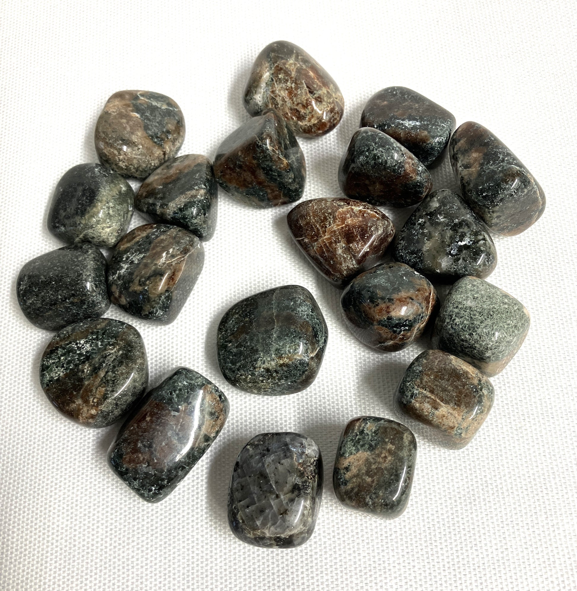 Group of Green Garnet Crystals on a white fabric background