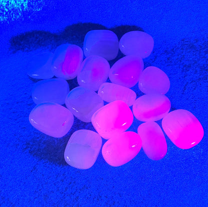 Pink Calcite Crystals under UV light on a blue background