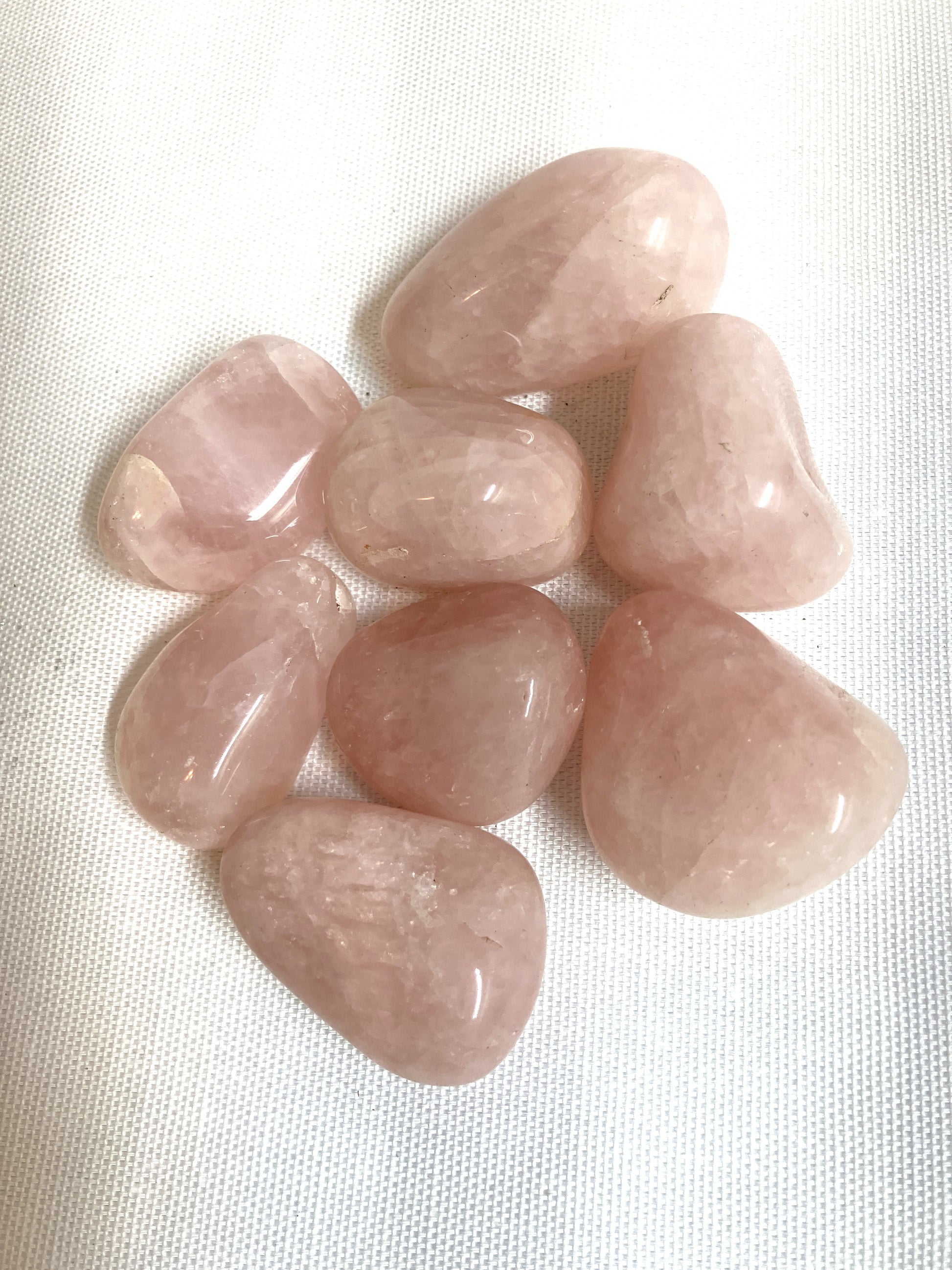 Group of Rose Quartz Crystals on a white fabric background