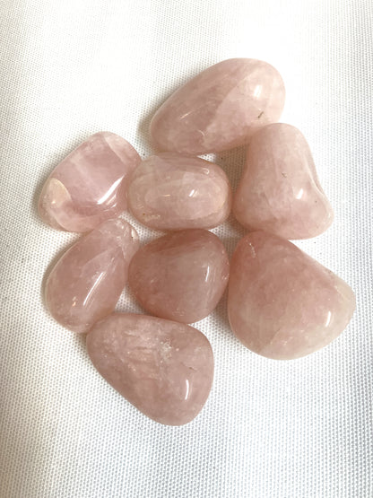 Group of Rose Quartz Crystals on a white fabric background