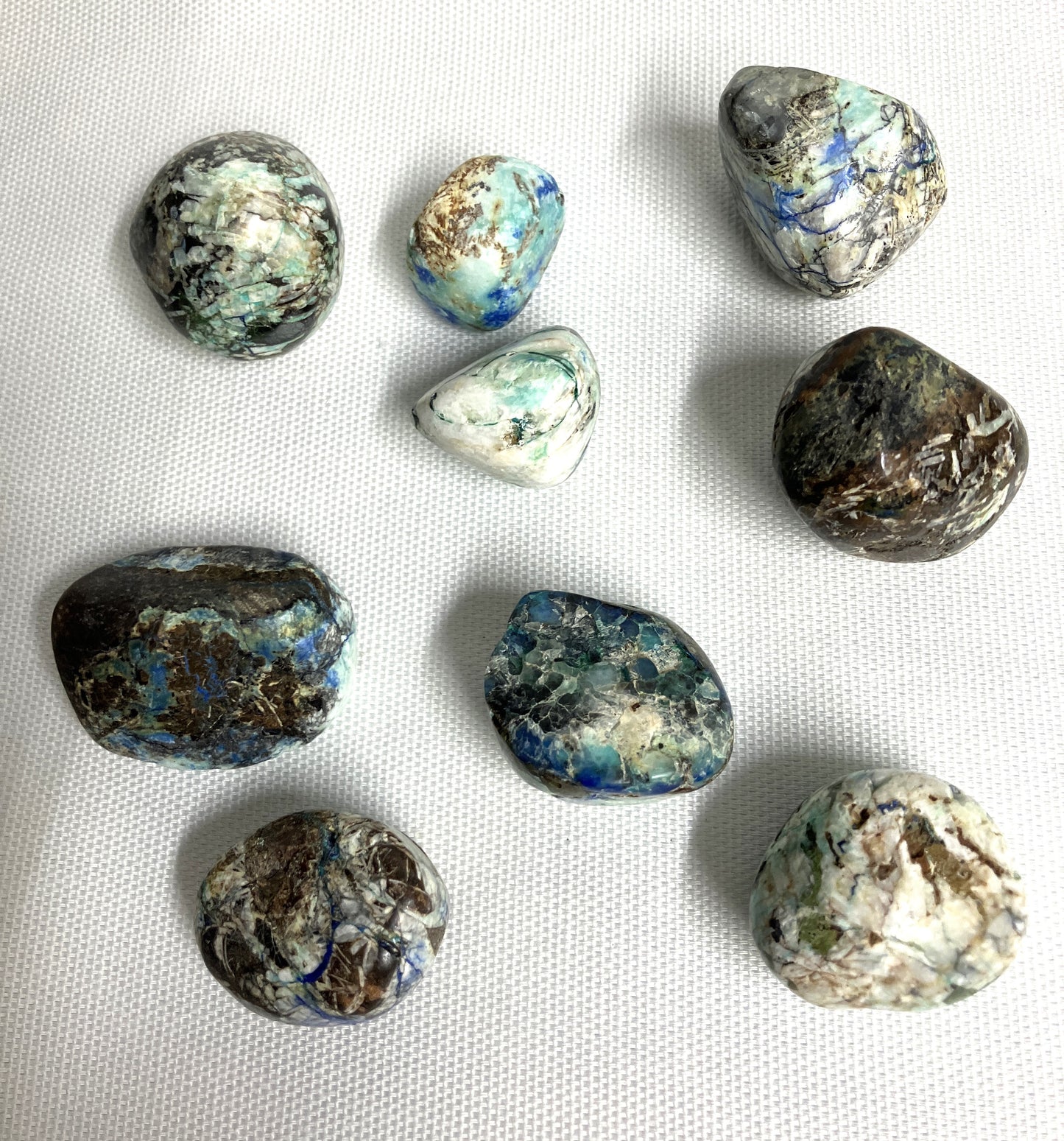 Front view of Azurite and Malachite Crystals on a white fabric background