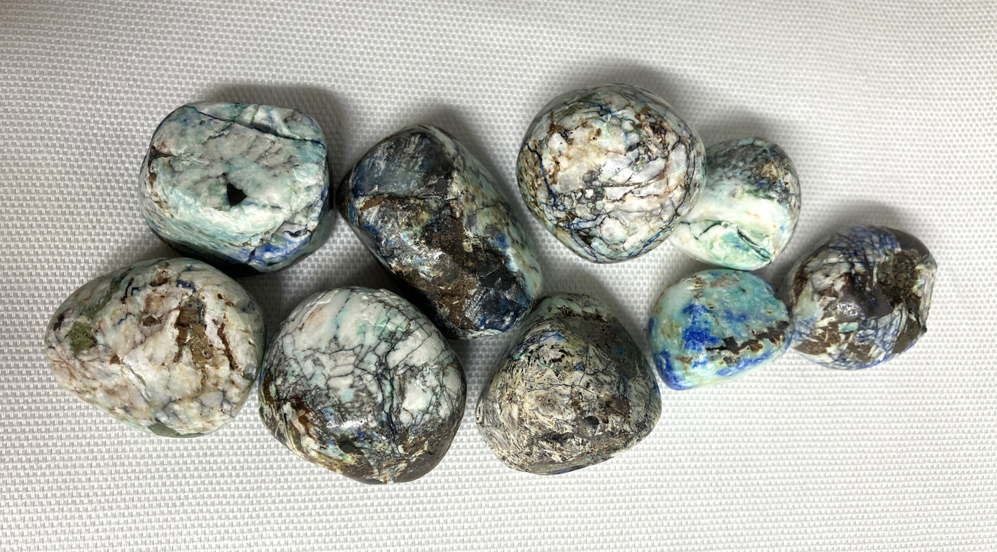 Closeup of Azurite and Malachite Crystals on a white fabric background