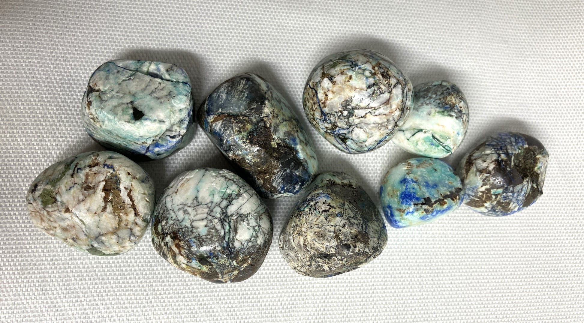 Closeup of Azurite and Malachite Crystals on a white fabric background