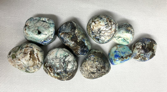 Closeup of Azurite and Malachite Crystals on a white fabric background