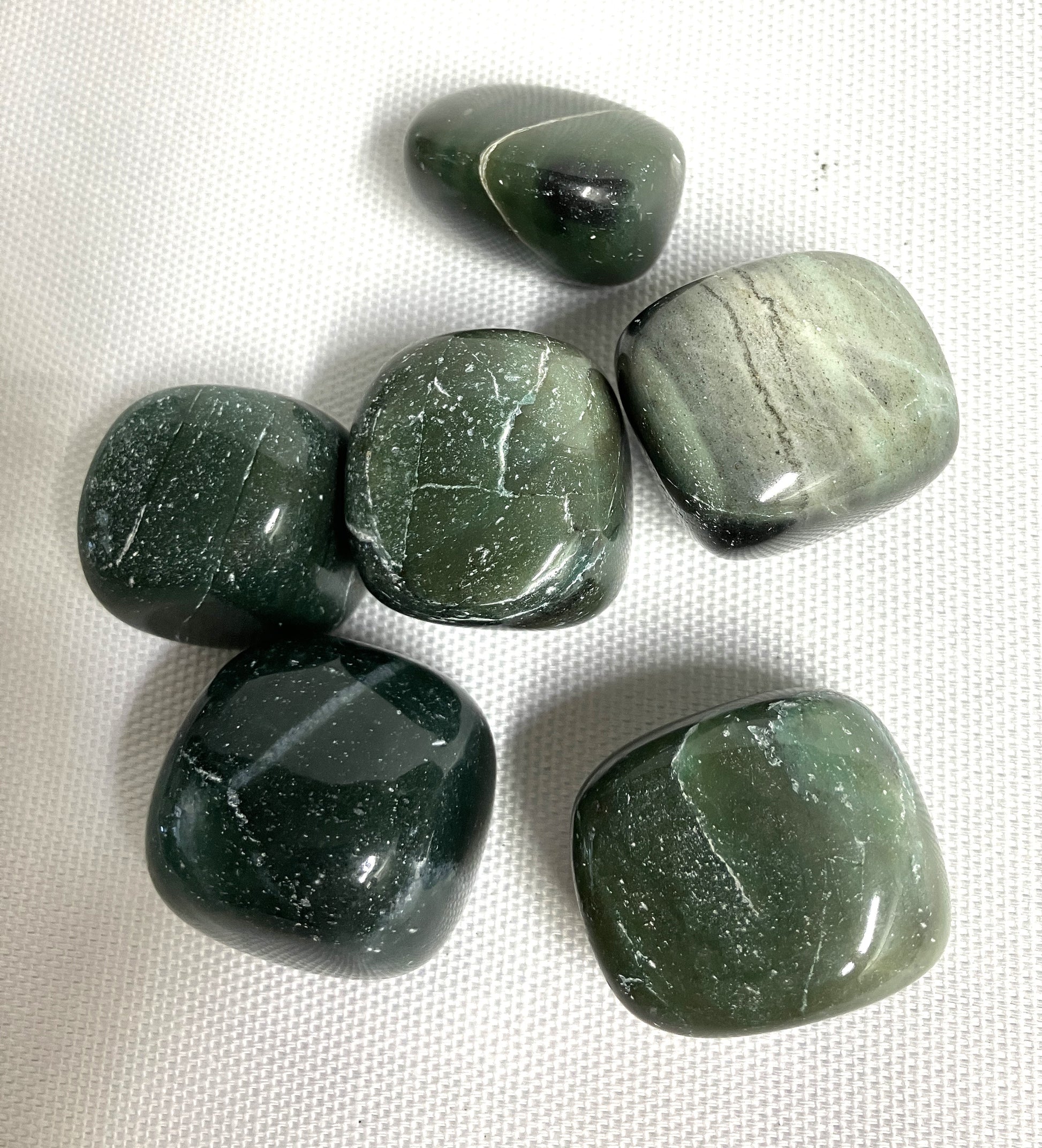 Showing the backside of some Bowenite tumbled crystals