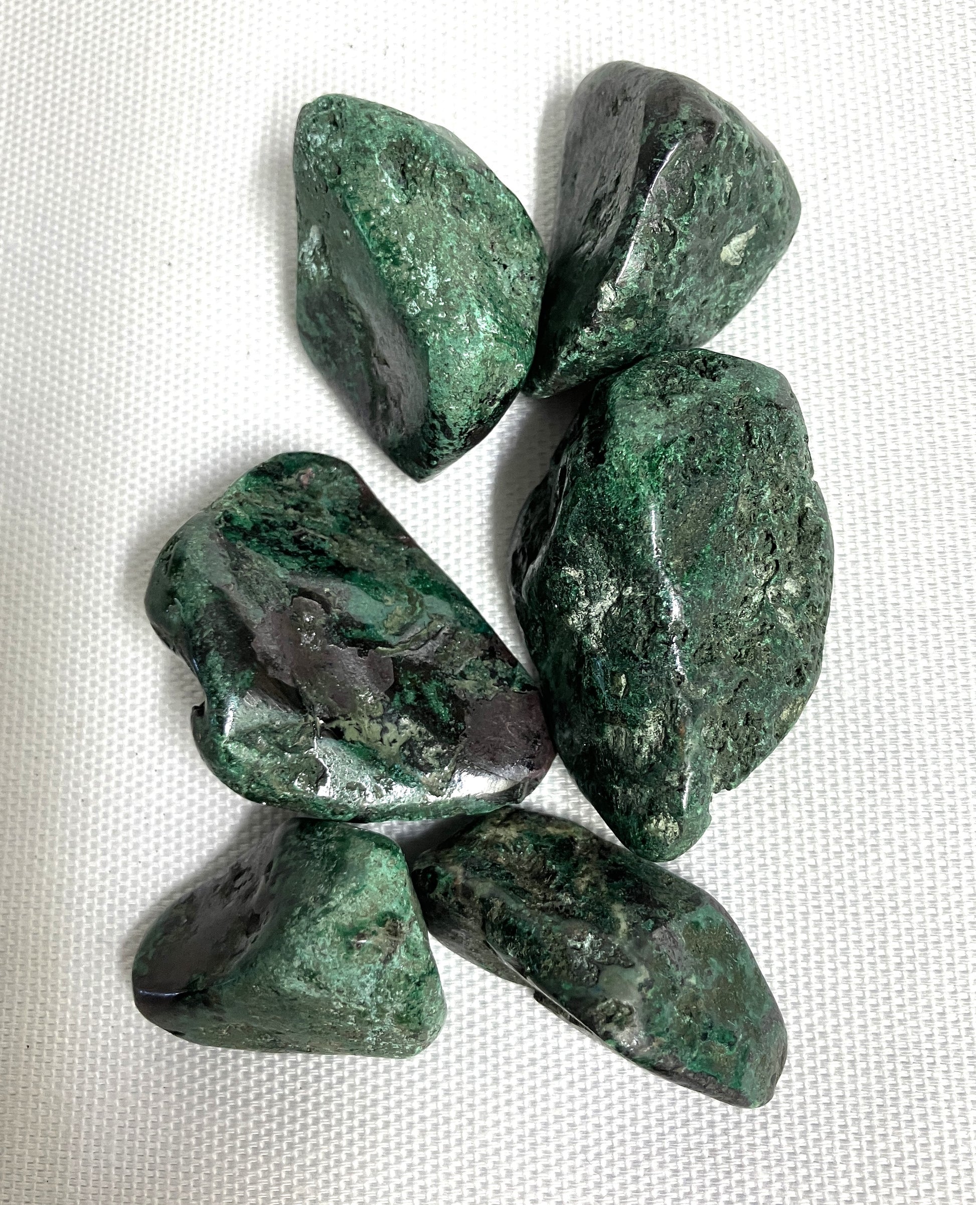 Back side of Cuprite Crystals on a white fabric background