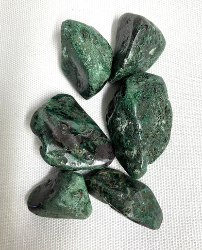 Back side of Cuprite Crystals on a white fabric background