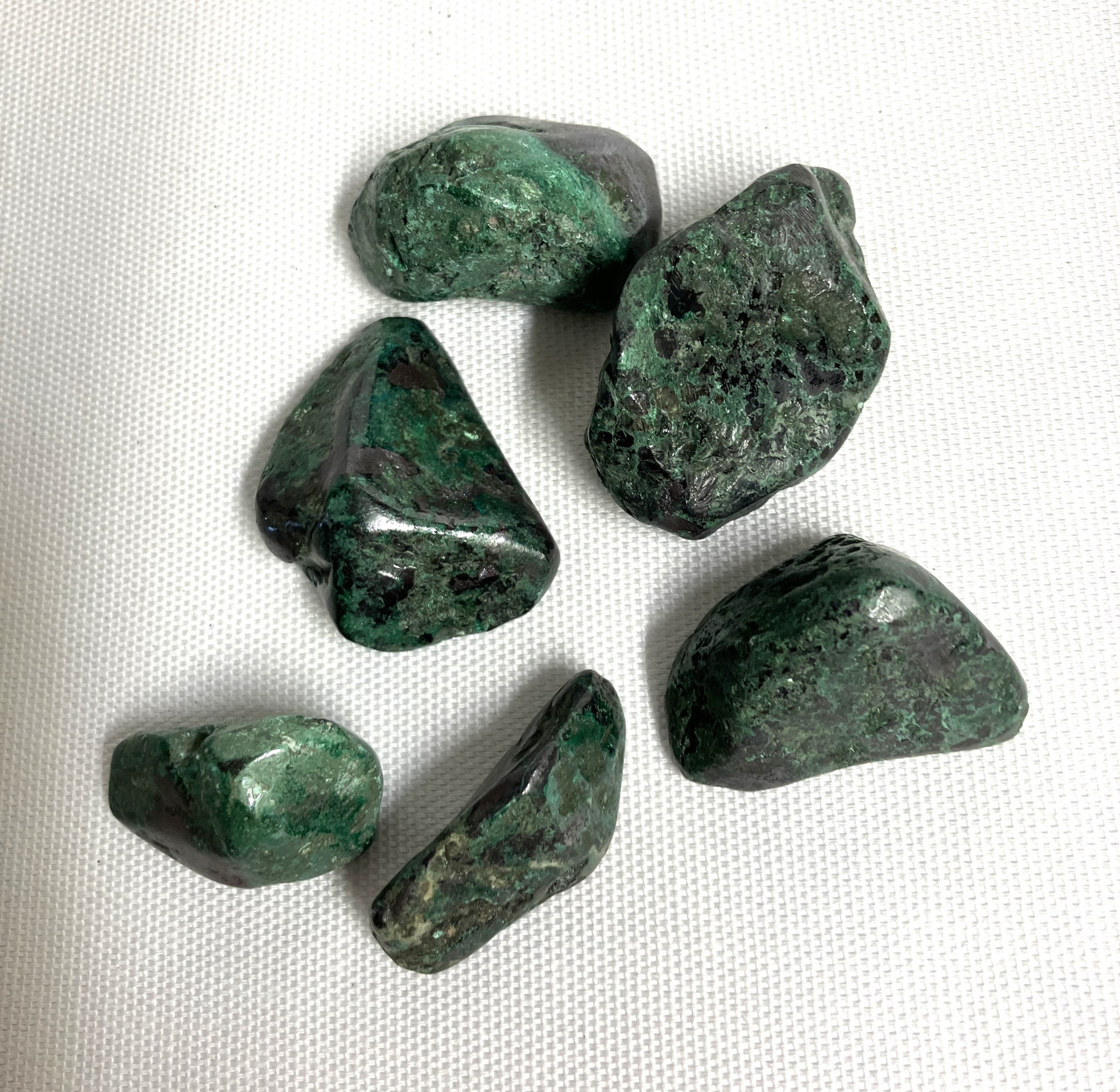 Front side of Cuprite Crystals on a white fabric background