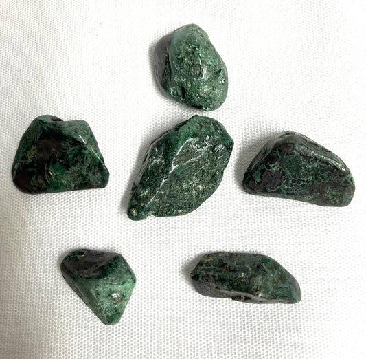 Six Cuprite Crystals on a white fabric background