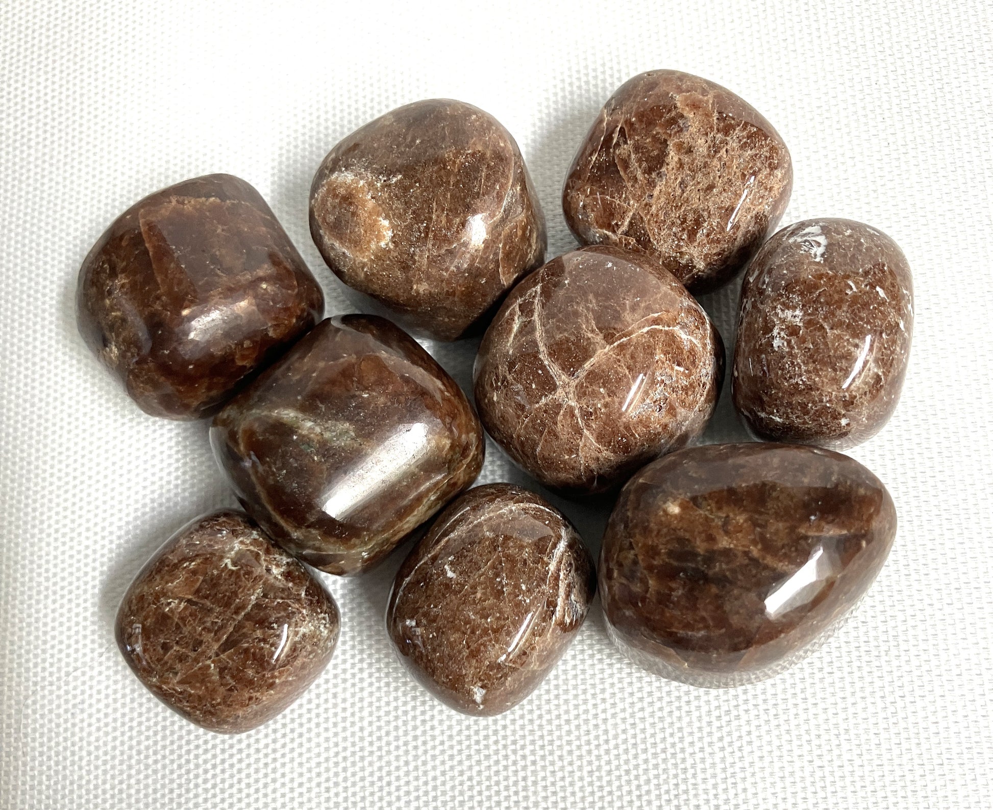 Closeup of Hessonite Garnet Crystals on a white fabric background