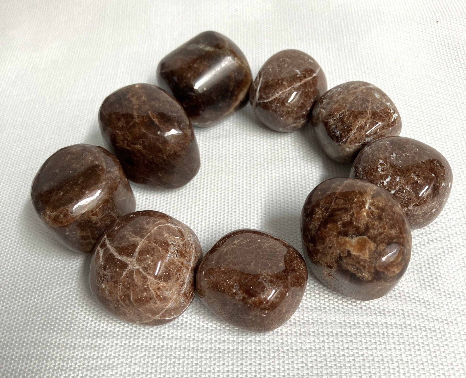 Back view of Hessonite Garnet Crystals on a white fabric background